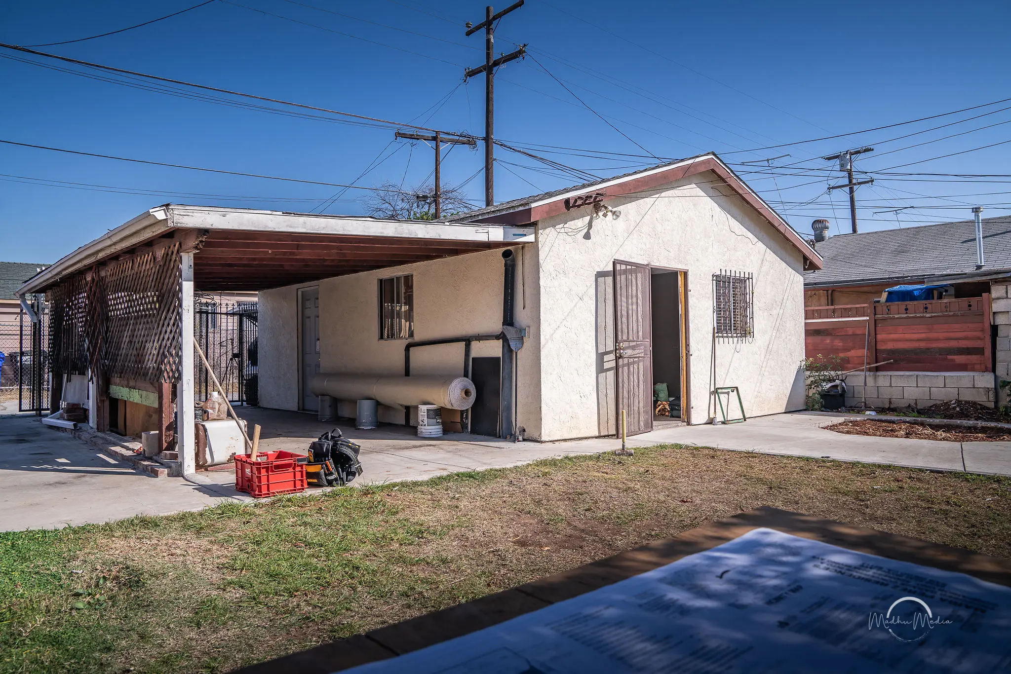 Backyard with shed and covered patio area.