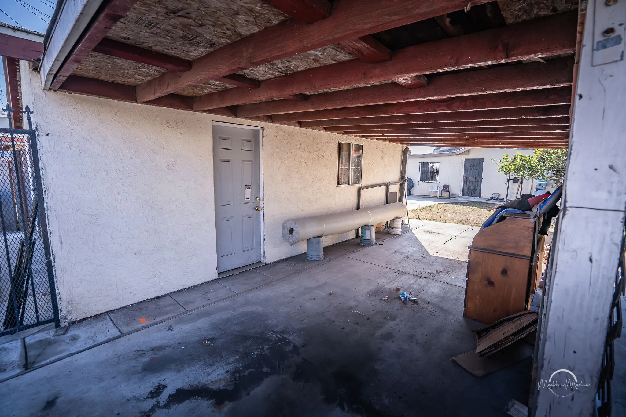 Covered outdoor area with concrete floor.