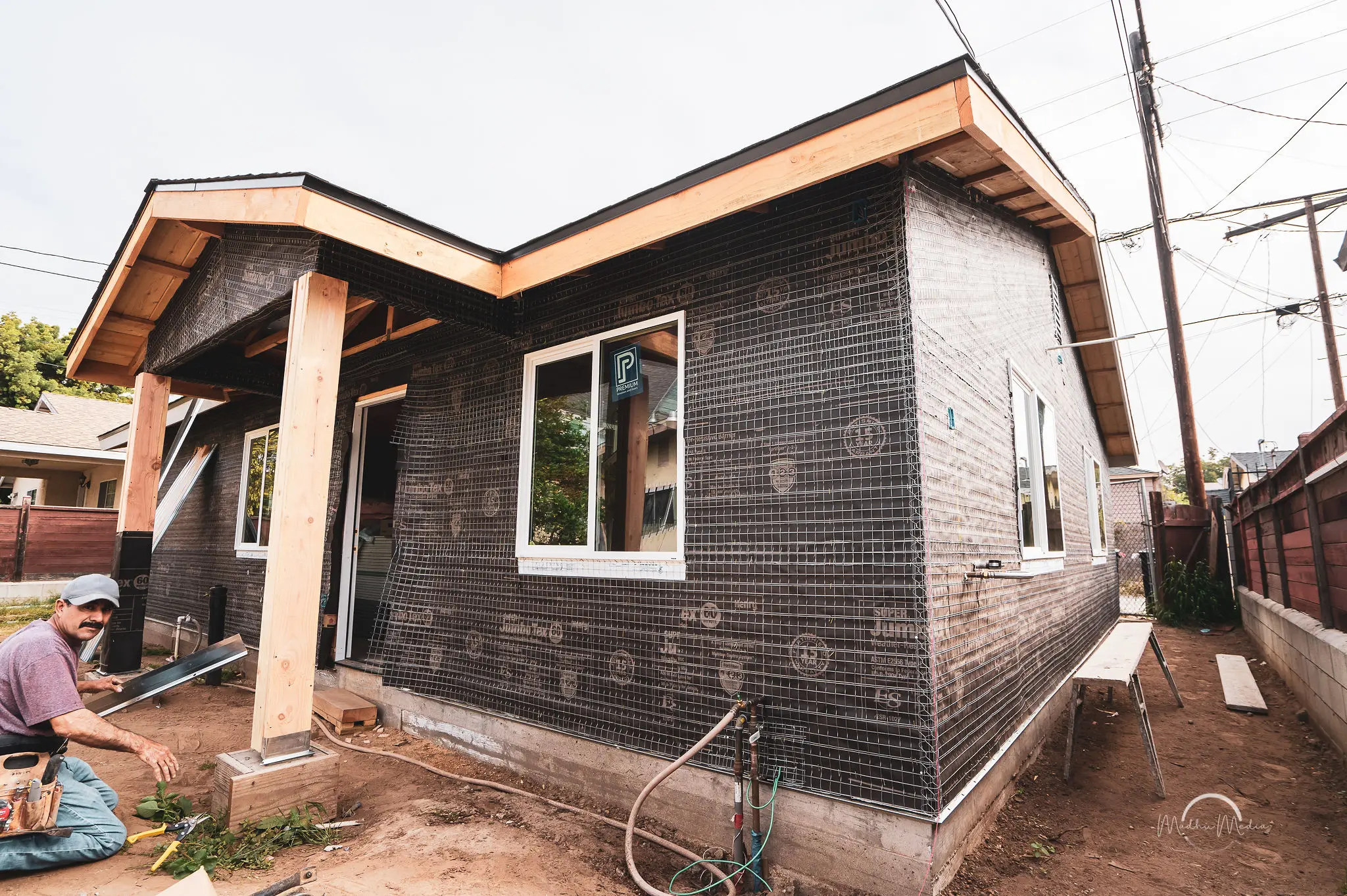 House under construction with a worker present.