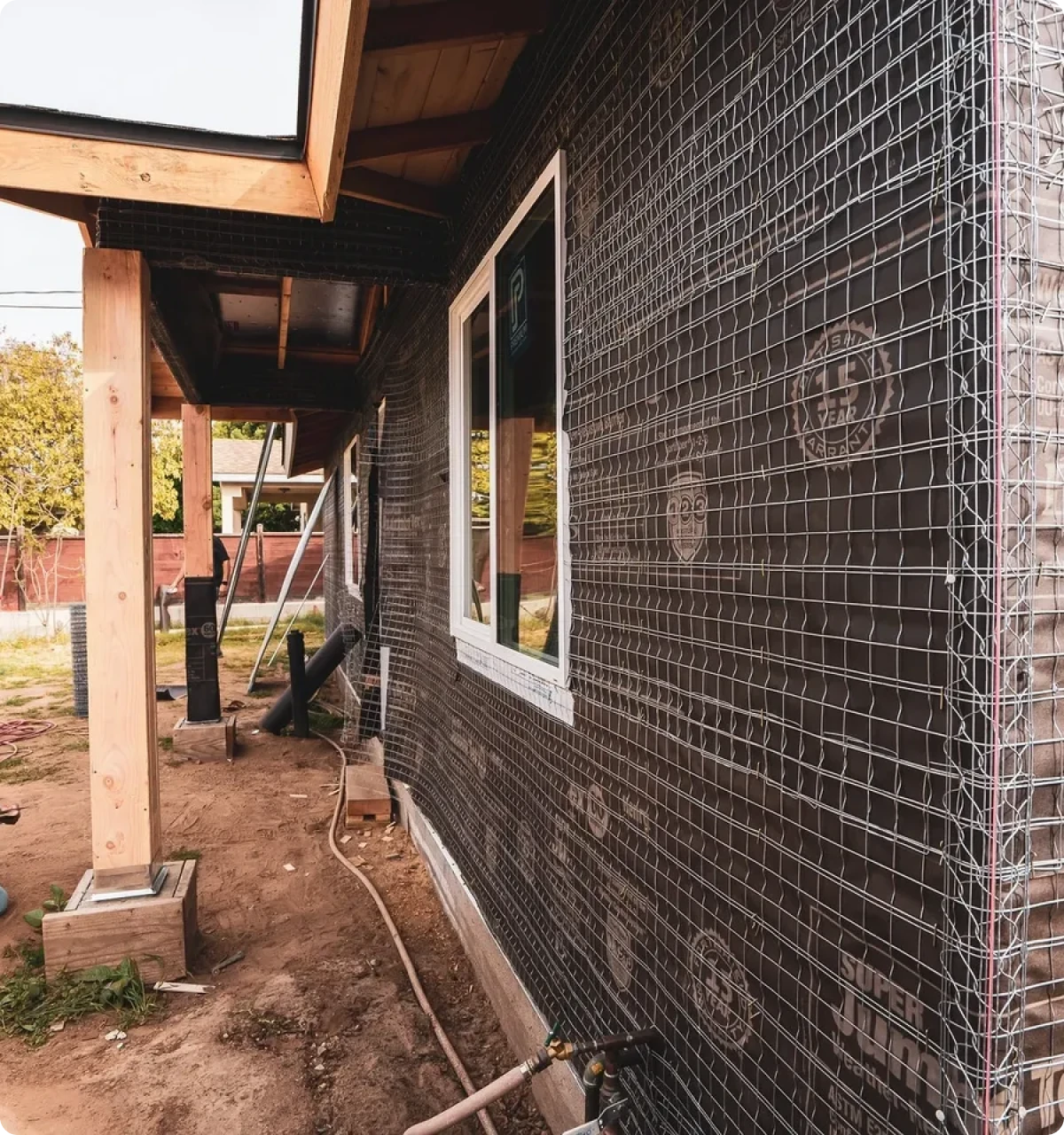 House under construction with wire mesh exterior.
